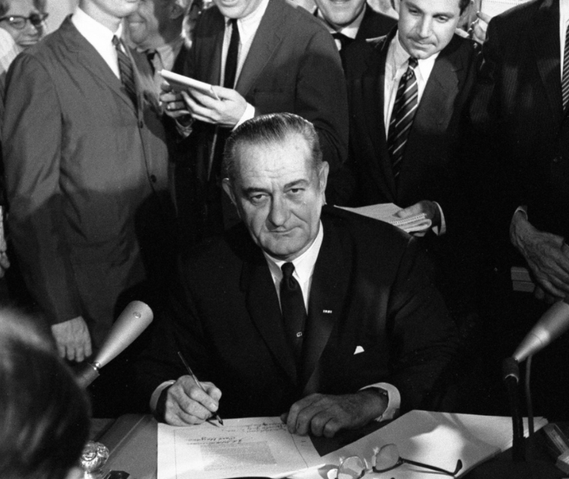 Photo of LBJ signing Civil Rights Act.