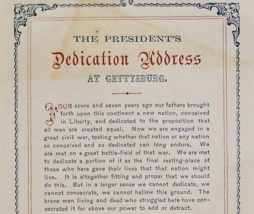 View of title and first full paragraph of semi-ornate printed version of Abraham Lincoln's Gettysburg Address, featuring decorative border and selective use of red ink in the text.