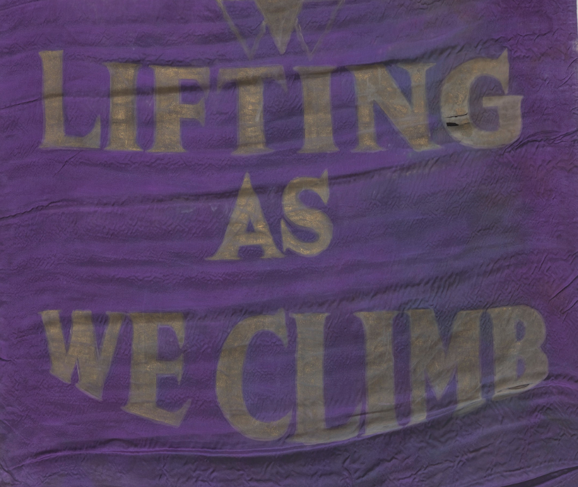A purple silk banner with gold fringe and the National Association of Colored Women’s Clubs' motto, "Lifting As We Climb" painted in large gold letters.