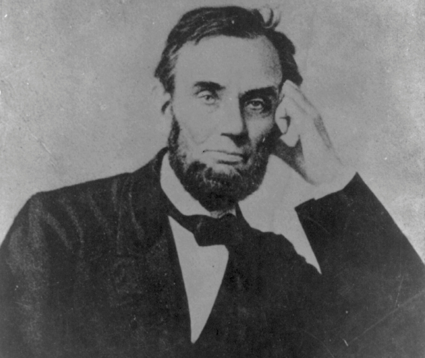 Photograph of President Abraham Lincoln, seated, with his left hand on his face