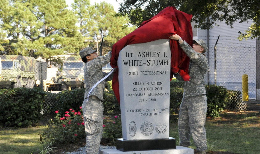 Photograph of soldiers unveiling the gravestone for Ashley White-Stumpf
