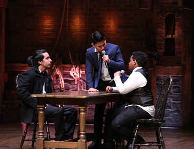 Three students on the Hamilton Musical set performing as part of the EduHam program
