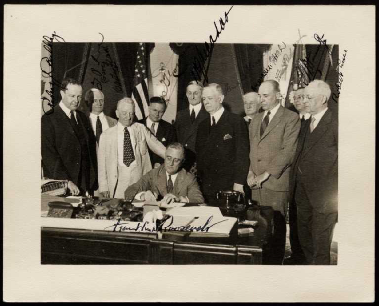 The Presidents vs. The Press (Photo of FDR sitting at desk, signing a bill and surrounded by other political figures)