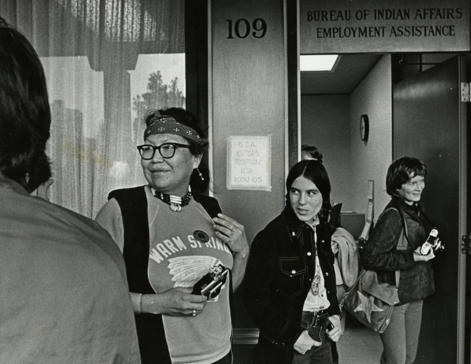 Black and white photograph of American Indian women standing outside an office at the Bureau of Indian Affairs, January 1973.