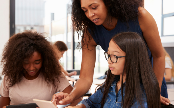 Photograph of Teacher helping two students