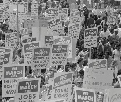 Black and white photograph showing the protest signs at the 1963 march on Washington, D.C. 