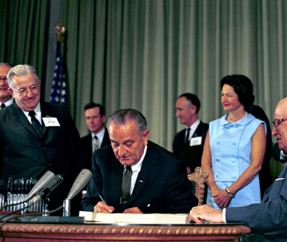 Photo fo LBJ signing Medicare legislation.