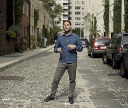 Video presenter standing in the street