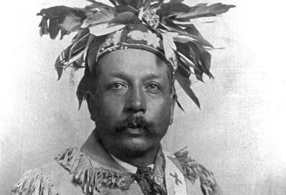 Photograph of a Iroquois leader wearing a headress and wampum belt