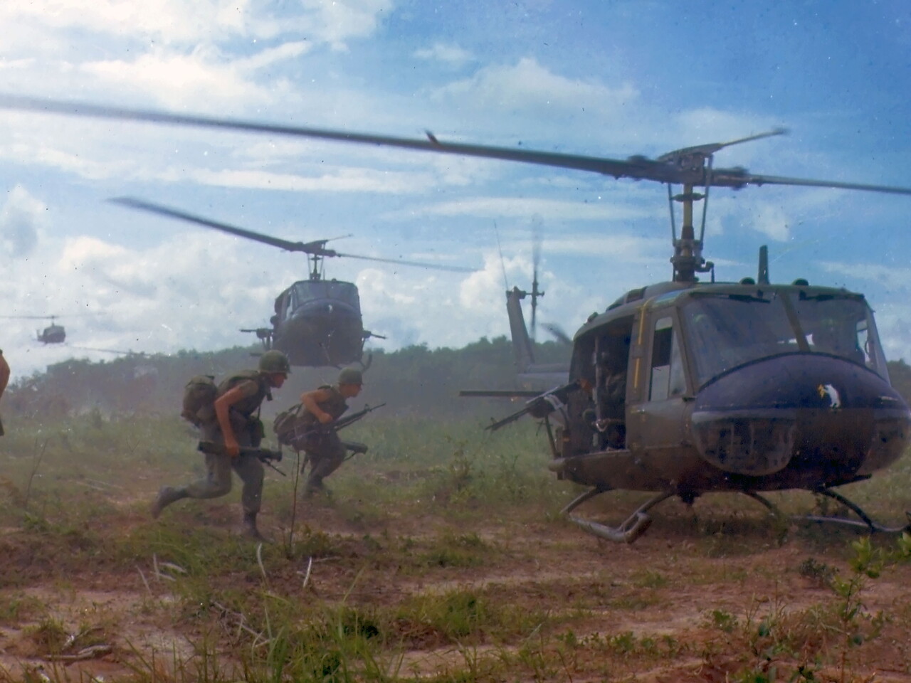 American soldiers running to a helicopter