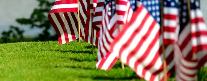 Cemetery with row of veteran graves with US flags