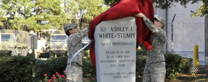 Photograph of soldiers unveiling the gravestone for Ashley White-Stumpf