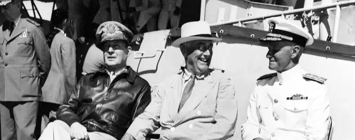 On board USS Baltimore (CA-68), at Pearl Harbor, Hawaii, 26 July 1944. Admiral William D. Leahy, the President's Chief of Staff, is standing in the left background. Official U.S. Navy Photograph, now in the collections of the National Archives