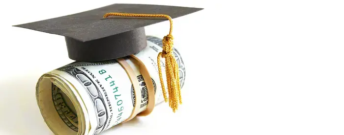 Roll of Hundred Dollar Bills with a Graduation Cap