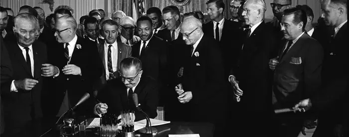 Lyndon B. Johnson signing a bill into law