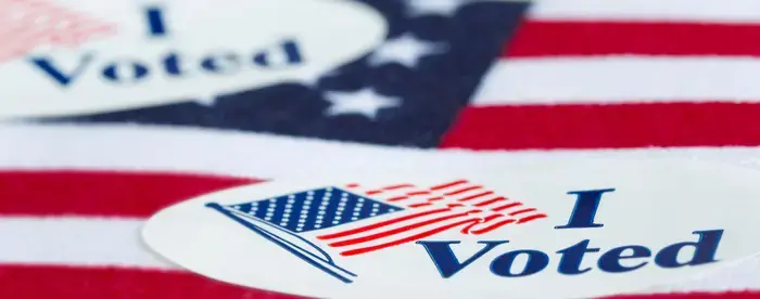 "I Voted" sticker resting on an American flag