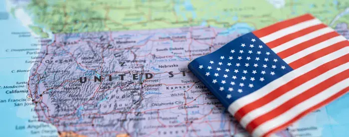 American flag resting atop a map of the United States