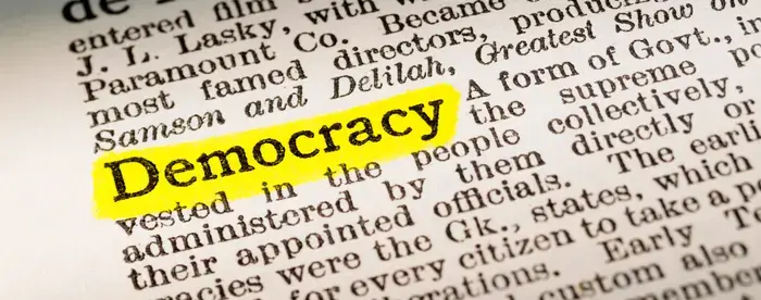 The word 'Democracy' highlighted in a dictionary