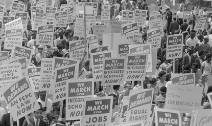 Black and white photograph showing the protest signs at the 1963 march on Washington, D.C.