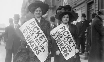 A photograph of two female strikers from Ladies Tailors union on the picket line.