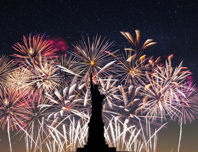 Fireworks in the background with silhouette of statue of liberty in foreground