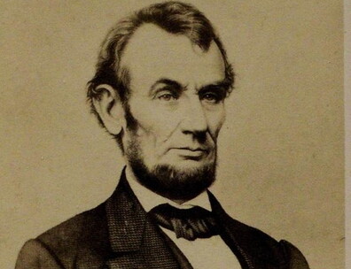 A photograph of an engraving of Abraham Lincoln seated.