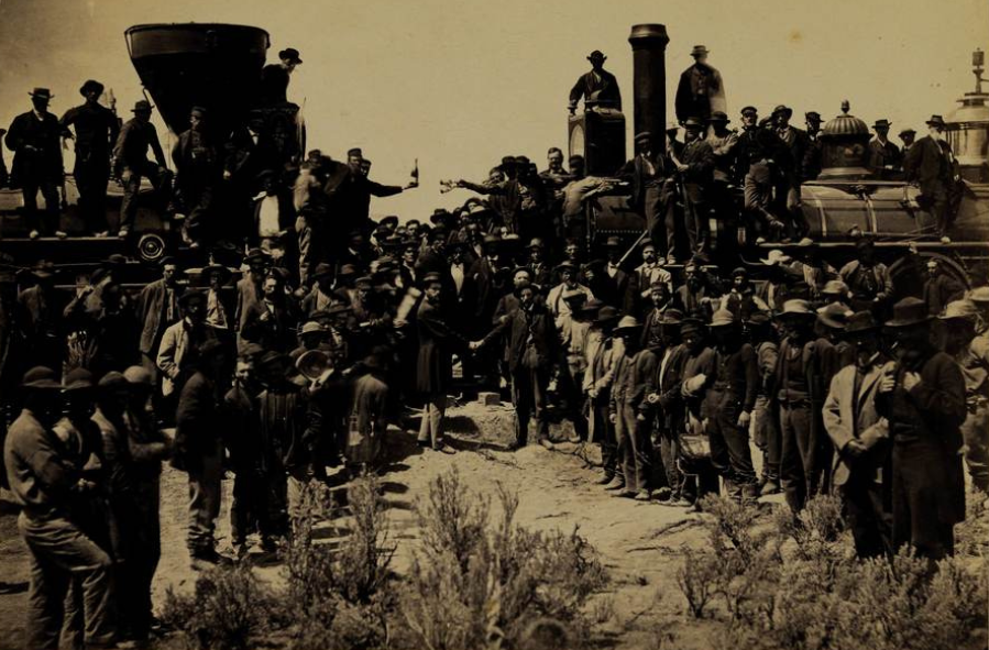 This photograph depicts the celebration marking the completion of the first transcontinental railroad lines at Promontory Summit, Utah, on May 10, 1869, when Leland Stanford, co-founder of the Central Pacific Railroad, connected the eastern and western sections of the railroad with a golden spike. 