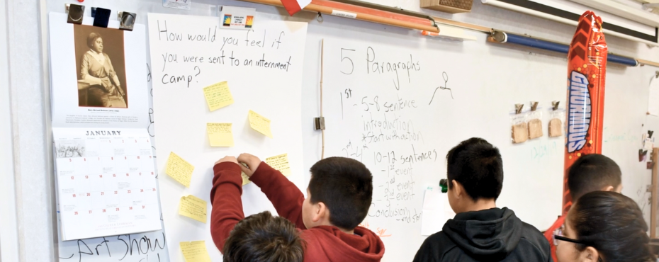 Students at a whiteboard with Gilder Lehrman calendar posted